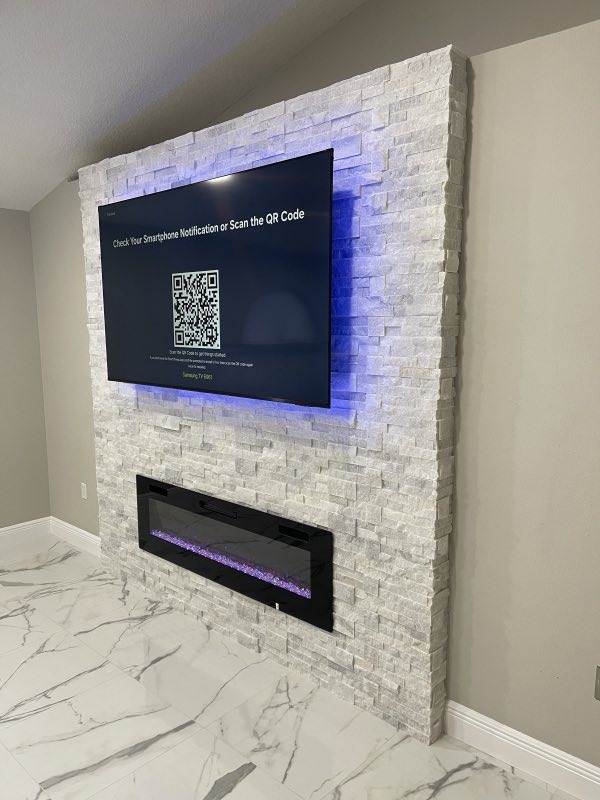 Stacked-stone feature wall with electric fireplace and mounted TV