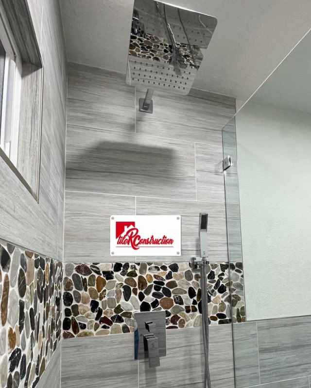Shower with wood-look tile and river-rock accent band